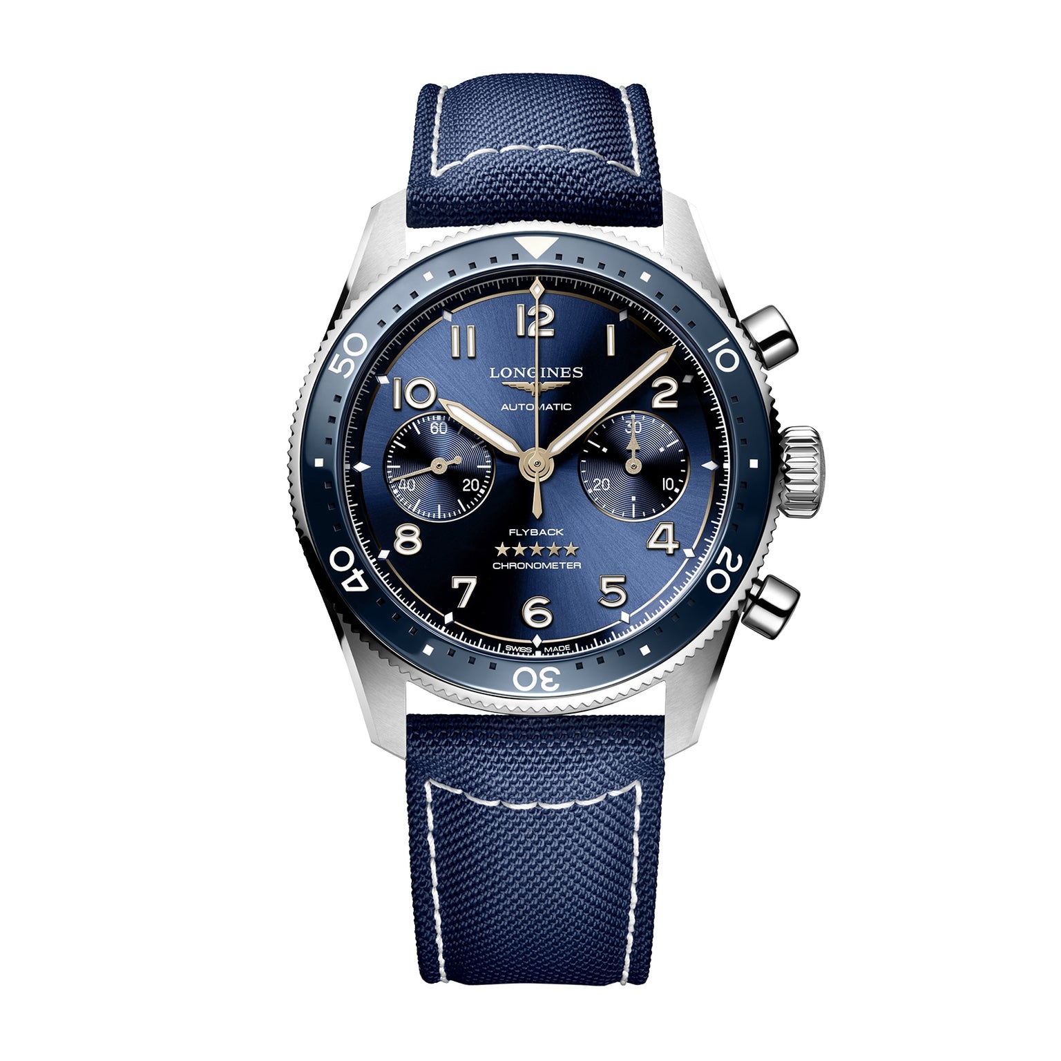 The Longines Spirit Flyback is a men’s wristwatch with a blue dial, chronograph subdials, stainless steel case, rotating bezel, and a blue fabric strap with white stitching.