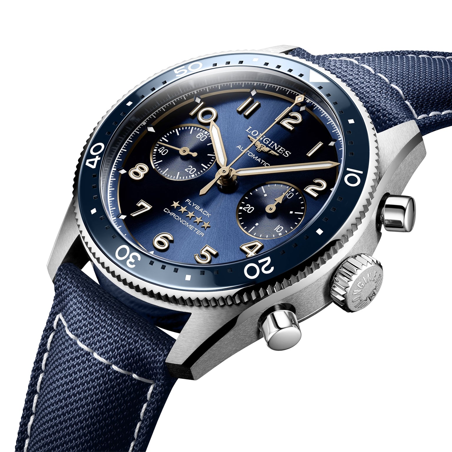 A close-up of the Longines Spirit Flyback wristwatch featuring a blue dial, three subdials, a blue bezel, and a blue fabric strap with white stitching in a stainless steel case.