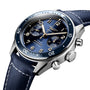 A close-up of the Longines Spirit Flyback wristwatch featuring a blue dial, three subdials, a blue bezel, and a blue fabric strap with white stitching in a stainless steel case.