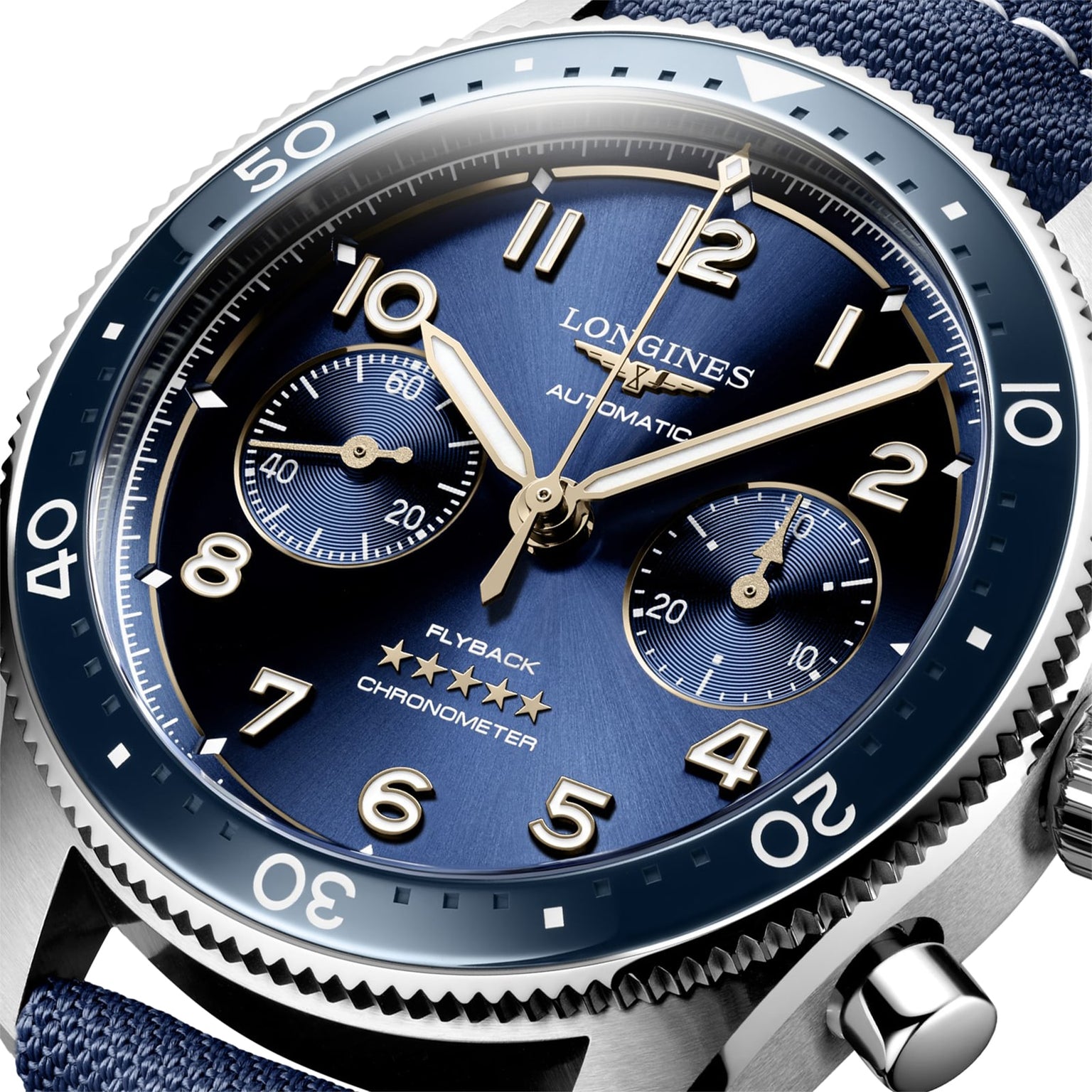 Close-up of the Longines Spirit Flyback, featuring a blue dial, gold hands, chronograph subdials, stainless steel case, rotating bezel, and displaying Flyback and Chronometer.
