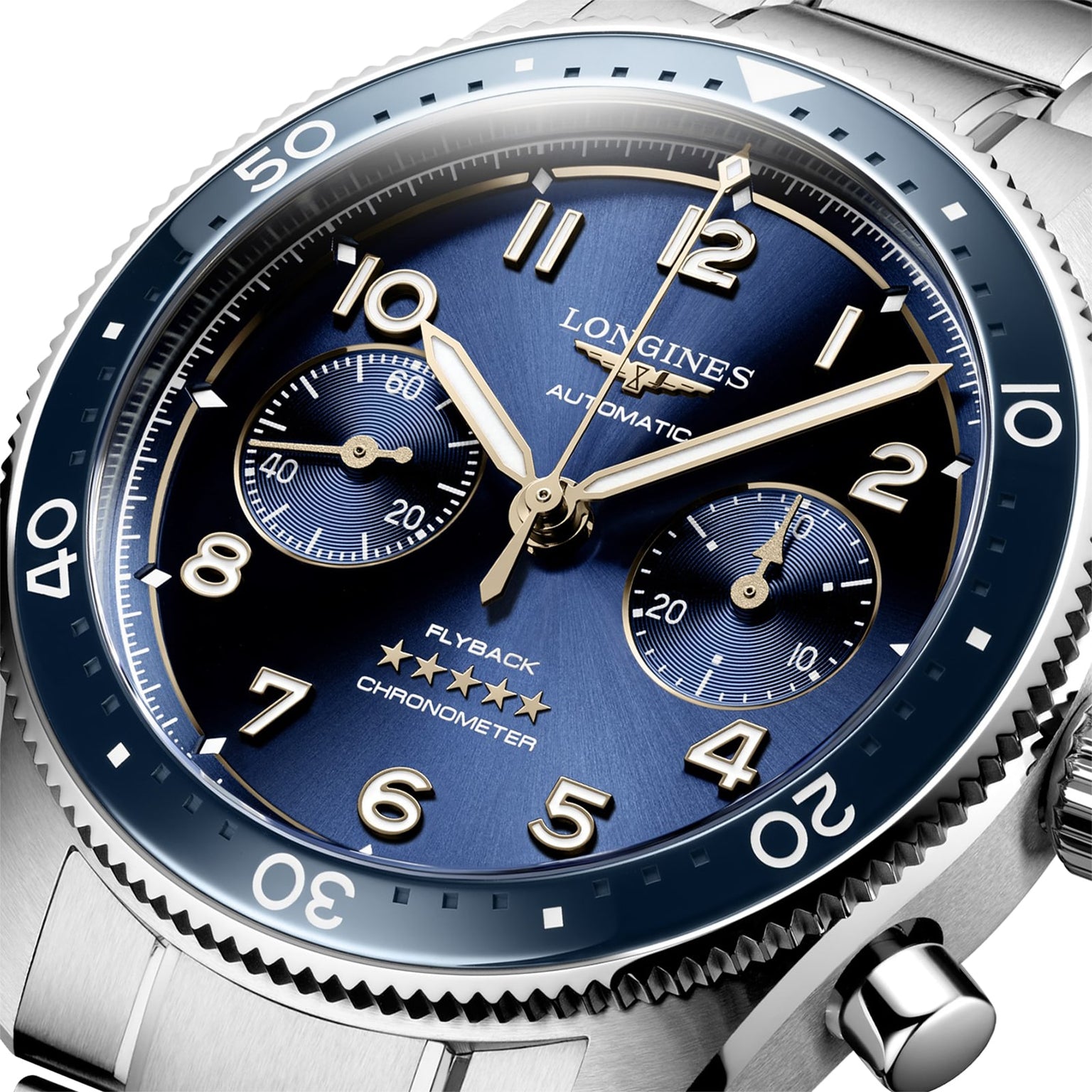 Close-up of a Longines Spirit Flyback watch with blue sunray dial, luminous hands, Arabic numerals, two subdials, and stainless steel case and bracelet. Powered by automatic calibre L791.