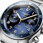 Close-up of a Longines Spirit Flyback watch with blue sunray dial, luminous hands, Arabic numerals, two subdials, and stainless steel case and bracelet. Powered by automatic calibre L791.
