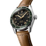 The Longines Spirit Zulu Time features a black dial, green bezel, brown leather strap, gold markers, stainless steel case, and a date display at 6 o’clock.