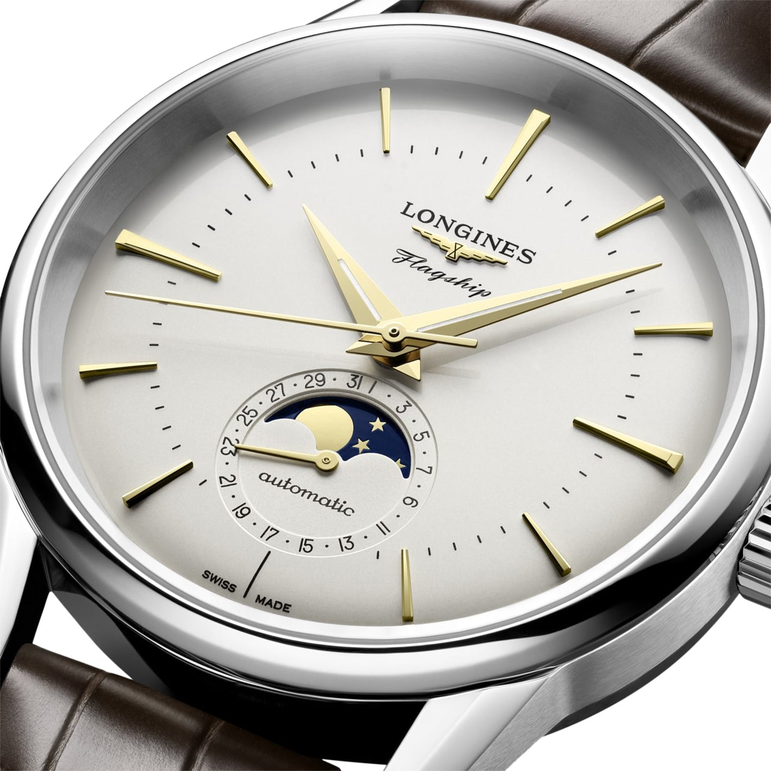Close-up of the Longines Flagship Heritage Moonphase watch, featuring gold hands and markers, an innovative moonphase display, date function, automatic movement, and a brown leather strap.