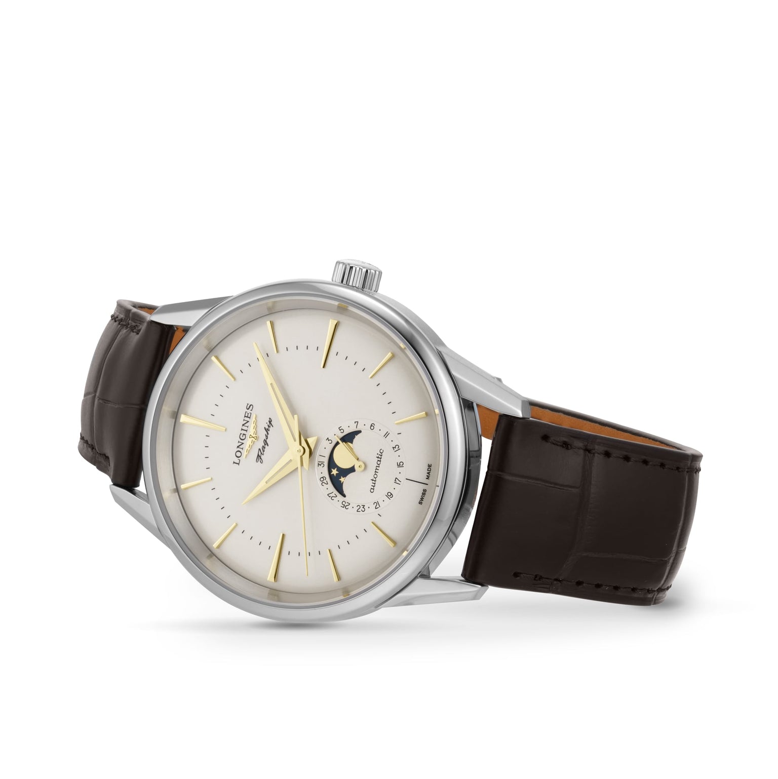 The Longines Flagship Heritage Moonphase is a silver wristwatch with a white dial, gold hands, date indicator, moon phase display, and black leather strap, shown angled to highlight its classic elegance.