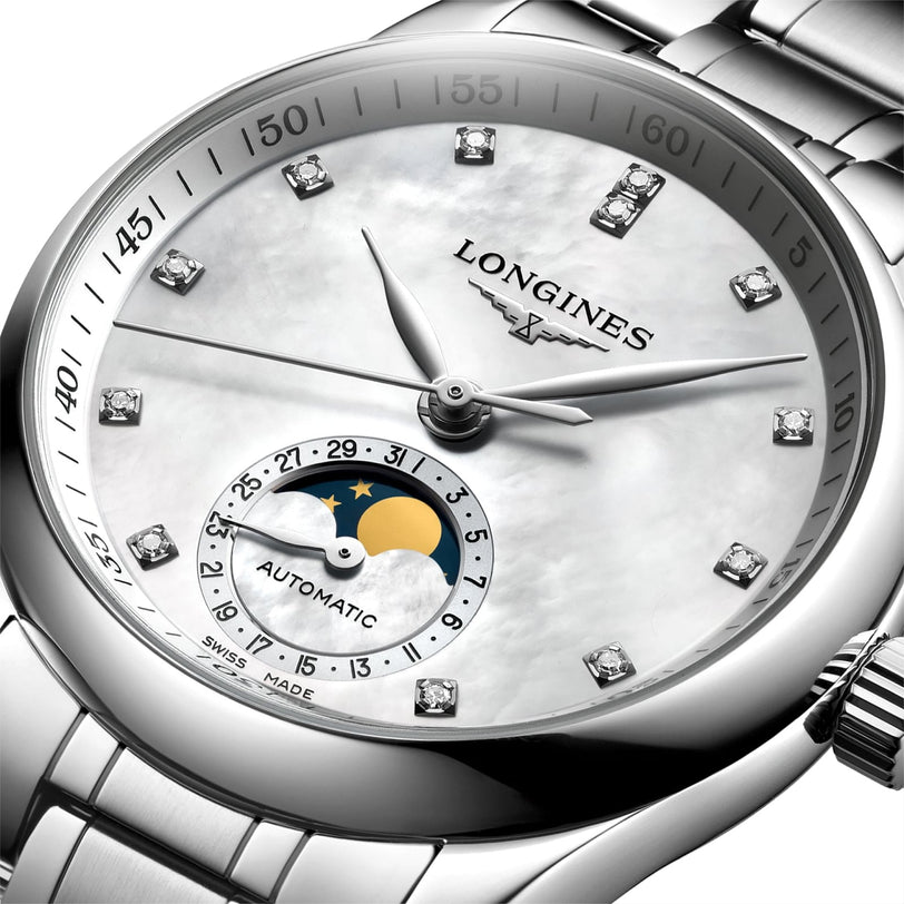 Close-up of the Longines Master Collection Moonphase wristwatch, featuring a silver case, white dial, diamond indexes, and a moonphase subdial with sun and moon design.