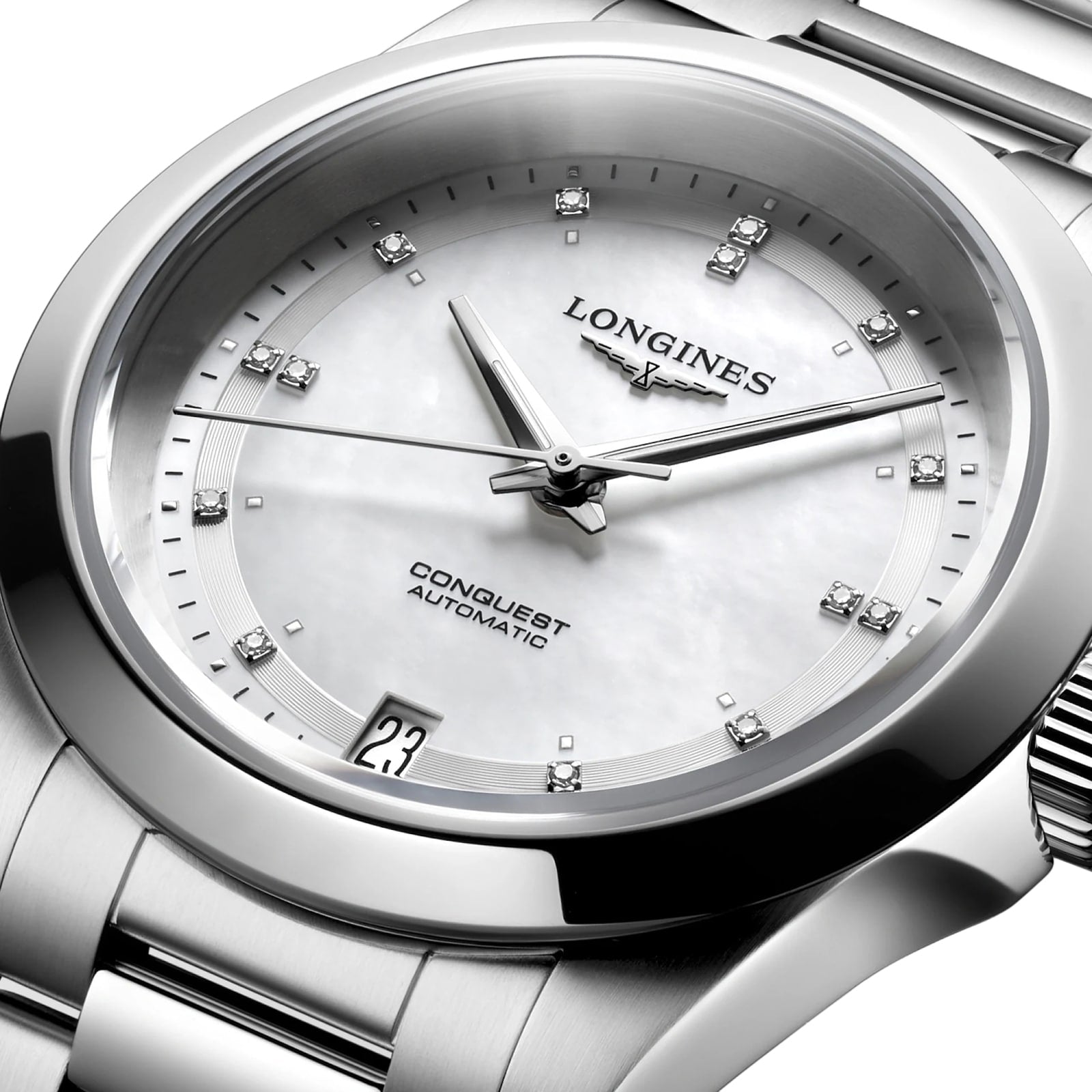 A close-up of the Longines Conquest wristwatch, showcasing its white dial with diamond hour markers, date window at 3 o’clock, and elegant stainless steel case.