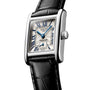 The Longines Mini DolceVita features a rectangular stainless steel case, white dial with blue hands, Roman numerals, small seconds subdial, and a black leather strap topped with sapphire crystal.