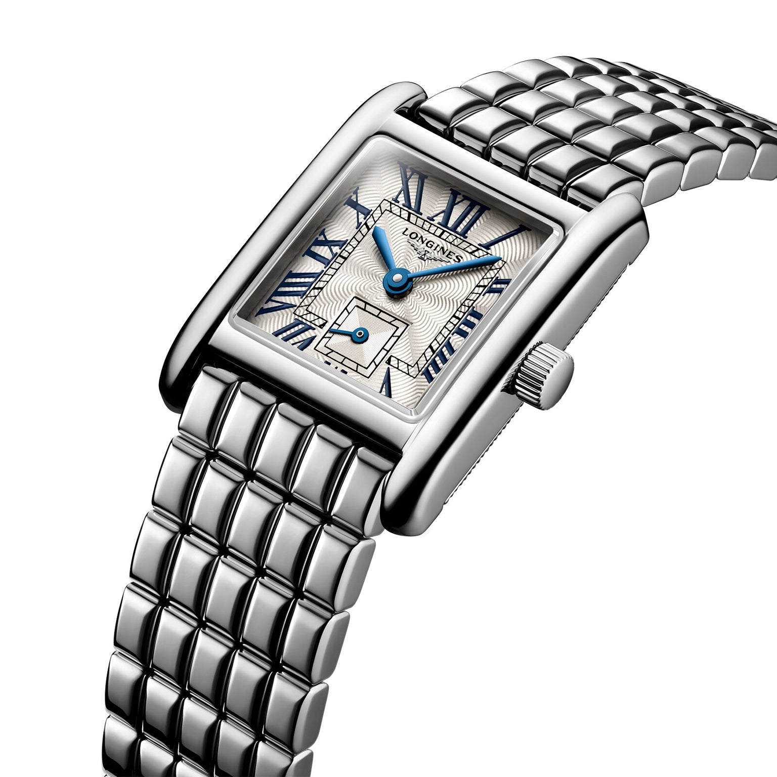 The Longines Mini DolceVita features a rectangular silver case, metal link band, white textured dial with blue hands and Roman numerals. The Longines name is displayed on the face, highlighting its modern luxury appeal.