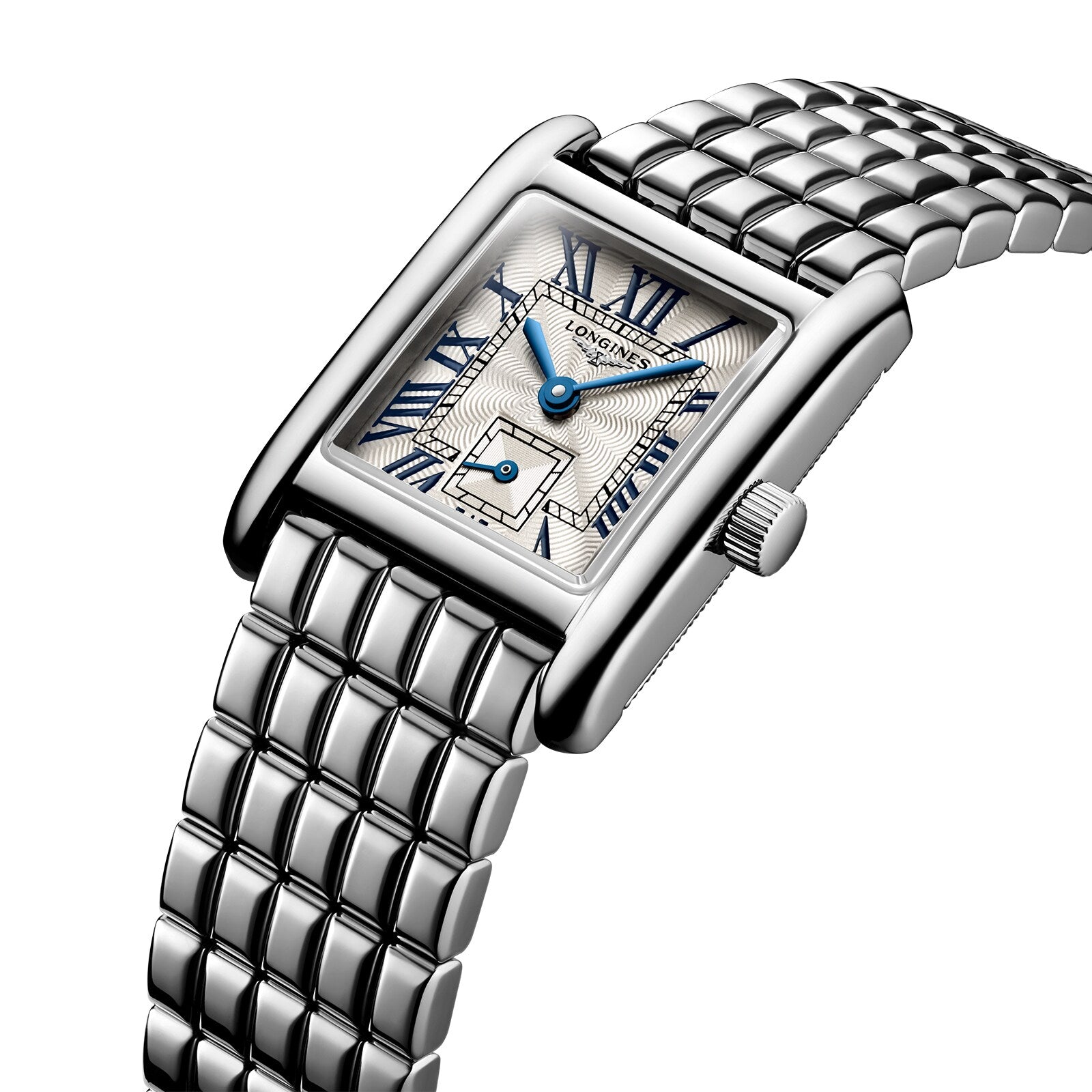 The Longines Mini DolceVita features a rectangular silver case, metal link band, white textured dial with blue hands and Roman numerals. The Longines name is displayed on the face, highlighting its modern luxury appeal.