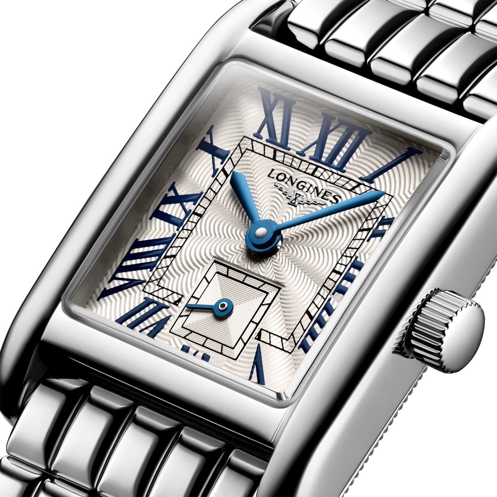 Close-up of the Longines Mini DolceVita wristwatch featuring a silver metal bracelet, blue hands, blue Roman numerals, and a date subdial on a textured white dial—a modern icon of luxury from Longines.