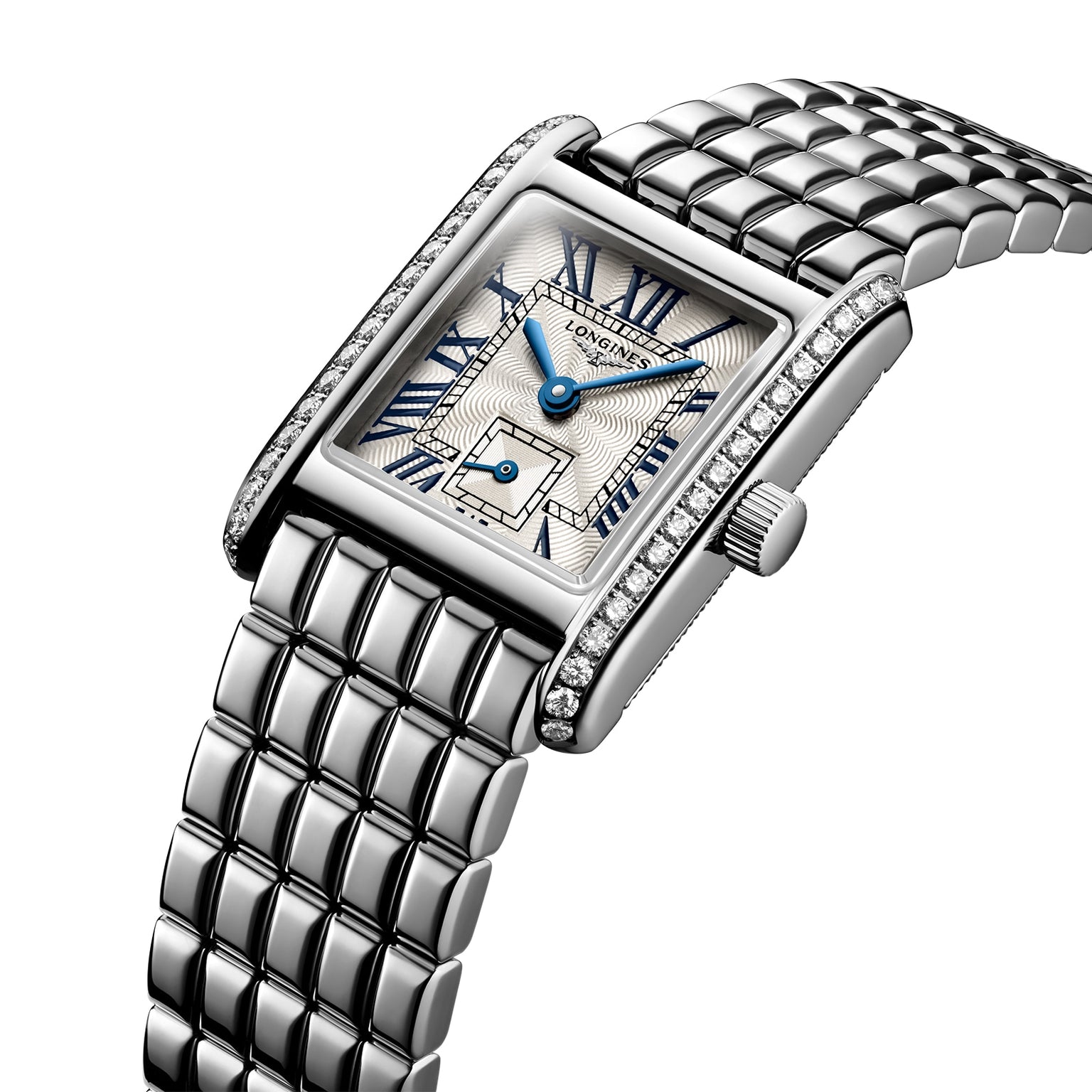 The Longines Mini DolceVita features a rectangular stainless steel case, metal link band, blue Roman numerals and hands, a small seconds dial, and a bezel adorned with Top Wesselton diamonds.