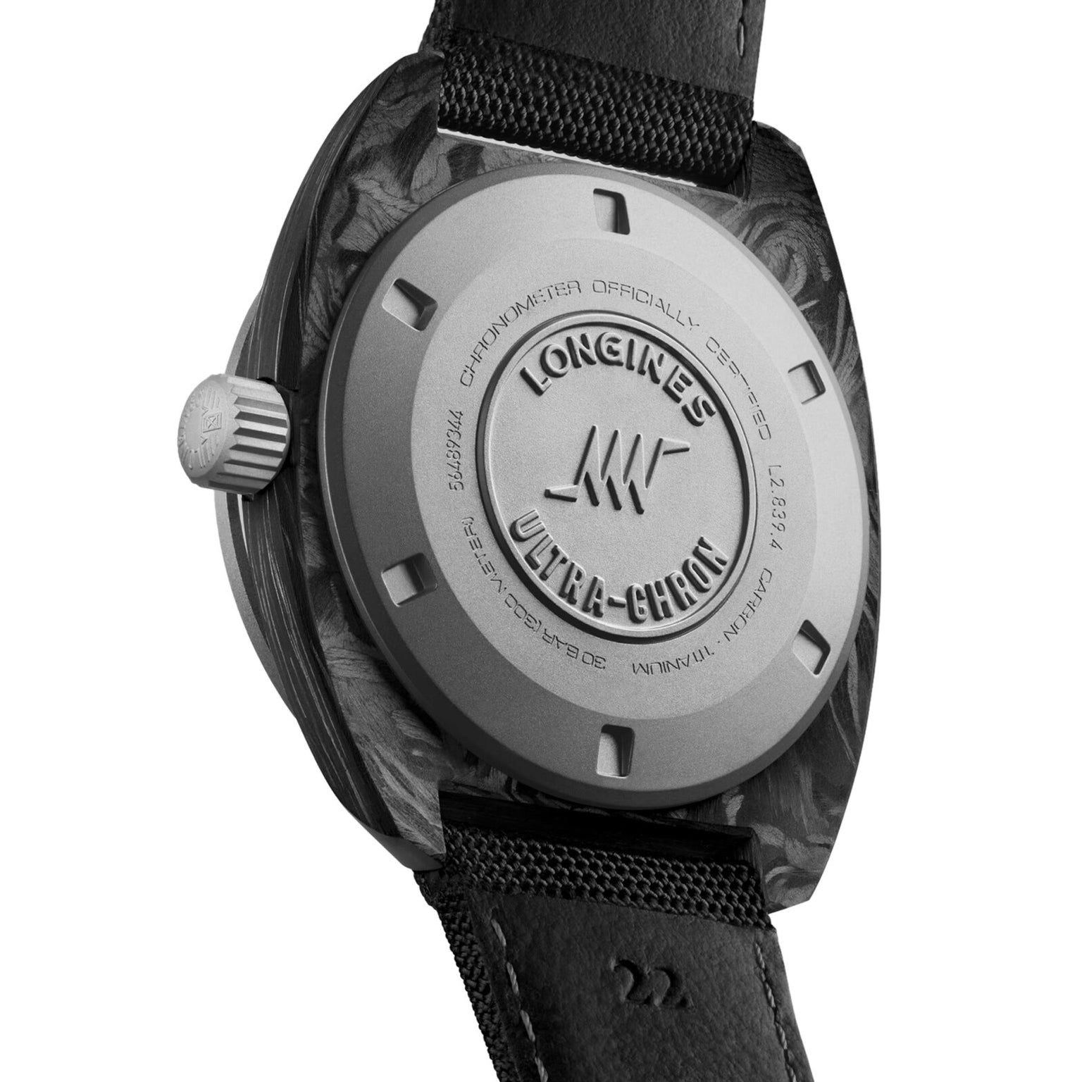 The image displays the case back of the Longines Ultra-Chron Carbon, featuring engraved branding and specifications that emphasize its high-frequency movement, paired with a black leather strap.