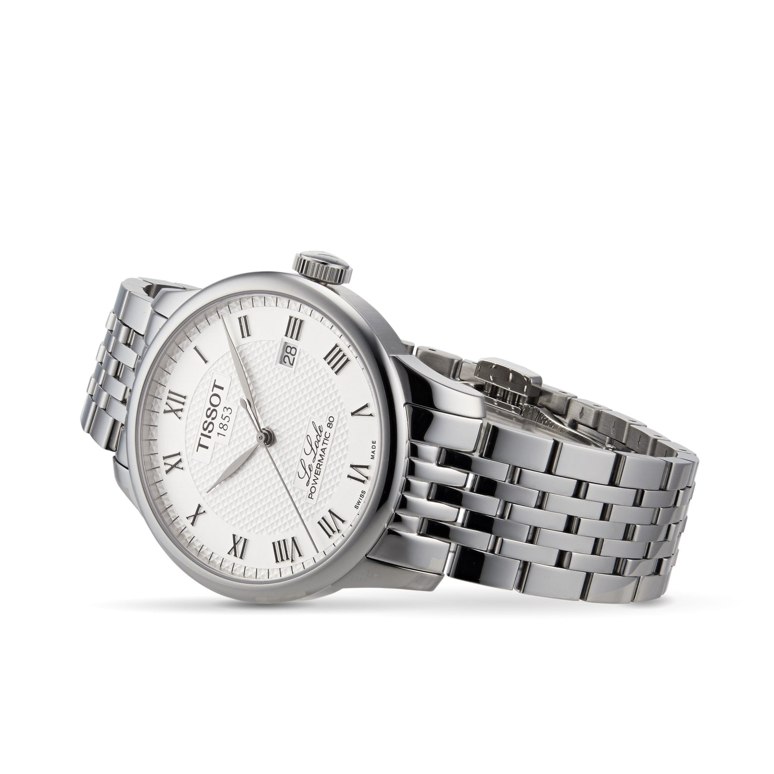 The Tissot Le Locle Powermatic 80 silver wristwatch features a white dial with Roman numerals, date display, and metal link band, presented on a white background. Inspired by the Swiss Jura Mountains.