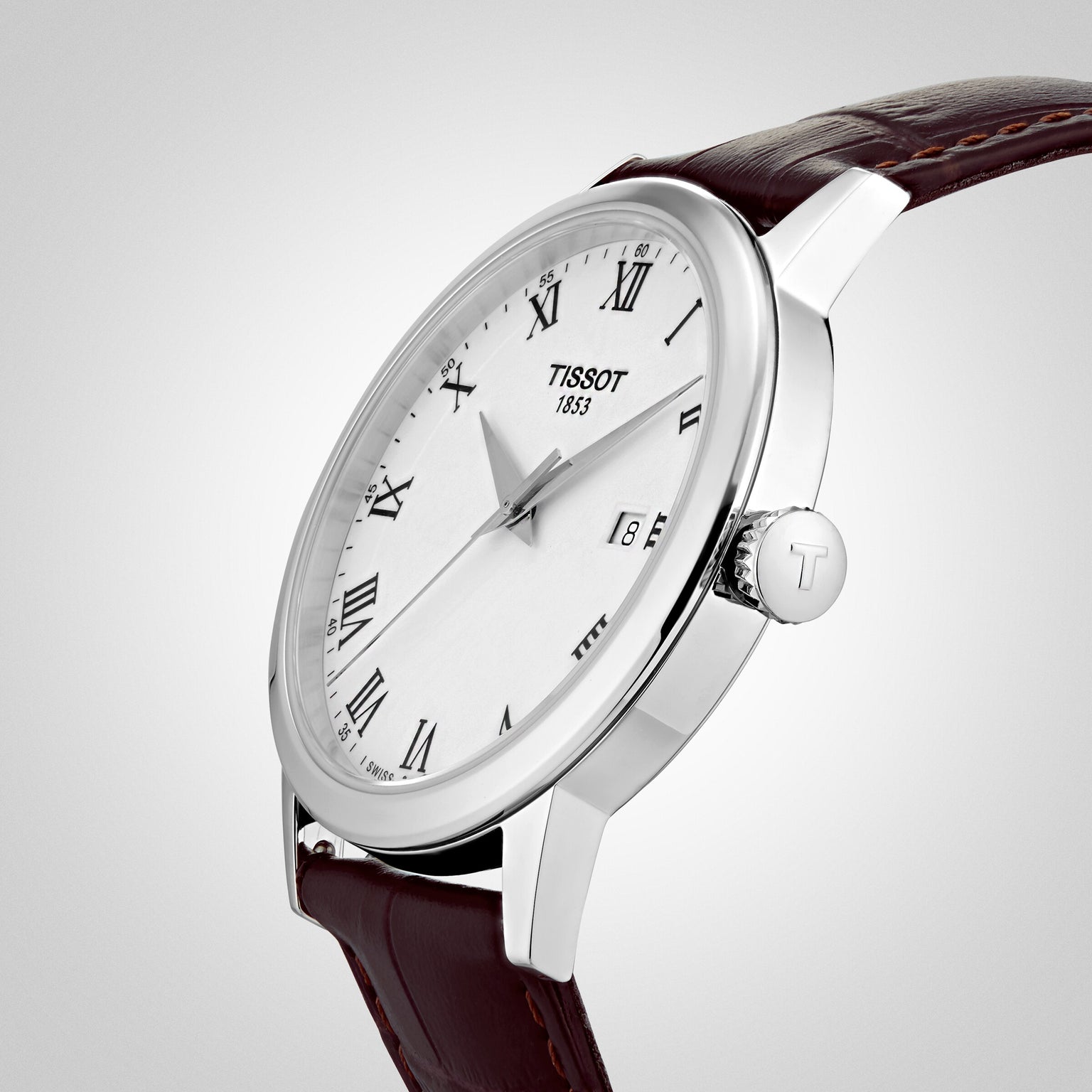The Tissot Classic Dream is a silver wristwatch with a white dial, black Roman numerals, date display, and brown leather strap—an elegant timepiece showcasing precise Swiss quartz movement.