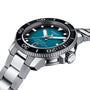 The Tissot Seastar 2000 Professional Powermatic 80 is a stainless steel divers watch featuring a teal textured dial, black rotating bezel, and date display at 6 o’clock.