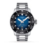 The Tissot Seastar 2000 Professional Powermatic 80 is a stainless steel diver’s watch with a blue dial, black bezel, silver markers, and date at 6 o’clock, shown against a white background.
