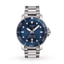 The Tissot Seastar 1000 Powermatic 80 features a stainless steel case, blue dial with white markers, date at 6 o’clock, unidirectional bezel, and Powermatic 80 movement.