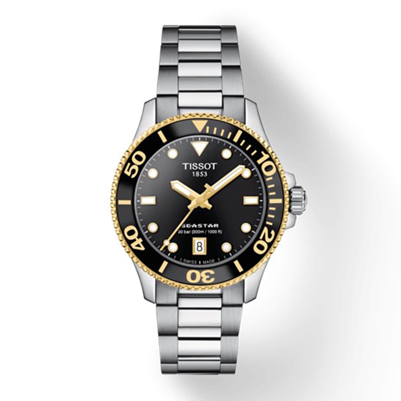 The Tissot Seastar 1000 features a silver and gold metal band, black bezel and dial, gold accents, SuperLuminova® hands, and a date display at 6 o’clock.