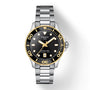 The Tissot Seastar 1000 features a silver and gold metal band, black bezel and dial, gold accents, SuperLuminova® hands, and a date display at 6 o’clock.