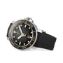 The Tissot Seastar 2000 Professional Powermatic 80 is a black and silver dive watch with a black rubber strap, round bezel with gold markings, Powermatic 80 movement, and date at 6 o’clock, shown on a white background.