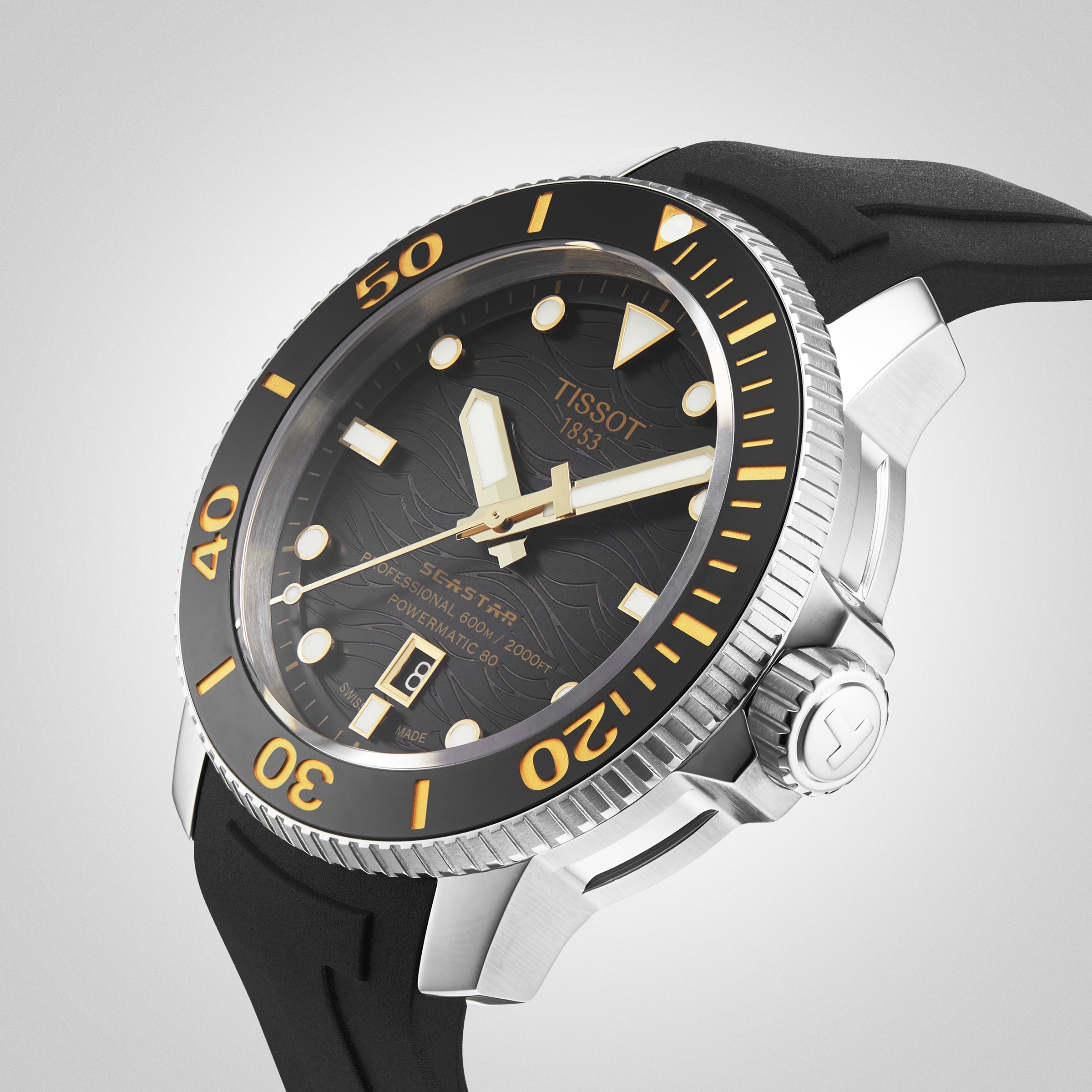 Close-up of a Tissot Seastar 2000 Professional Powermatic 80 automatic wristwatch with diver’s certification, black dial, yellow accents, date display, and black rubber strap.