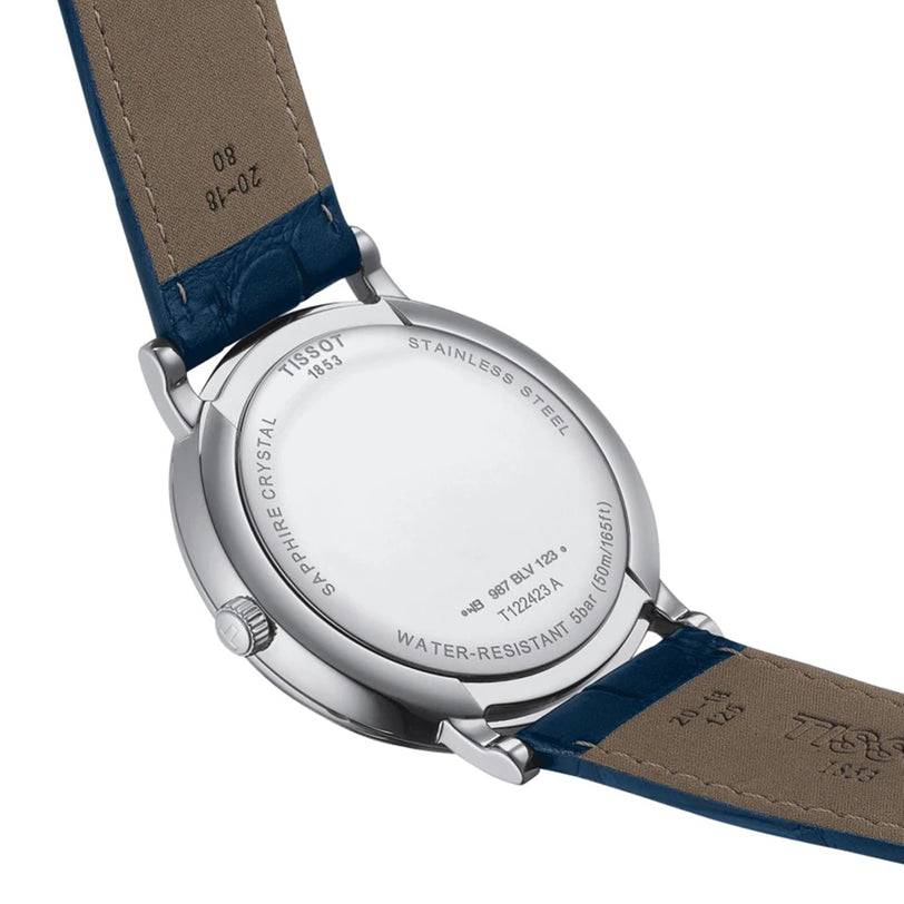 The back of the Tissot Carson Premium Moonphase wristwatch with a blue leather strap displays engravings about the model, water resistance, materials, and its Swiss-made quartz EOL movement.