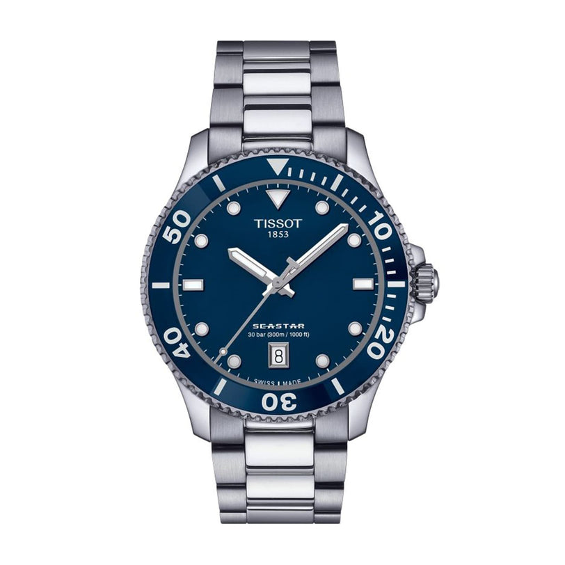The Tissot Seastar 1000 is a stainless steel divers watch with a blue dial, silver hands, white hour markers, and date display at 6 o’clock. It’s water resistant for daily wear and underwater adventures.