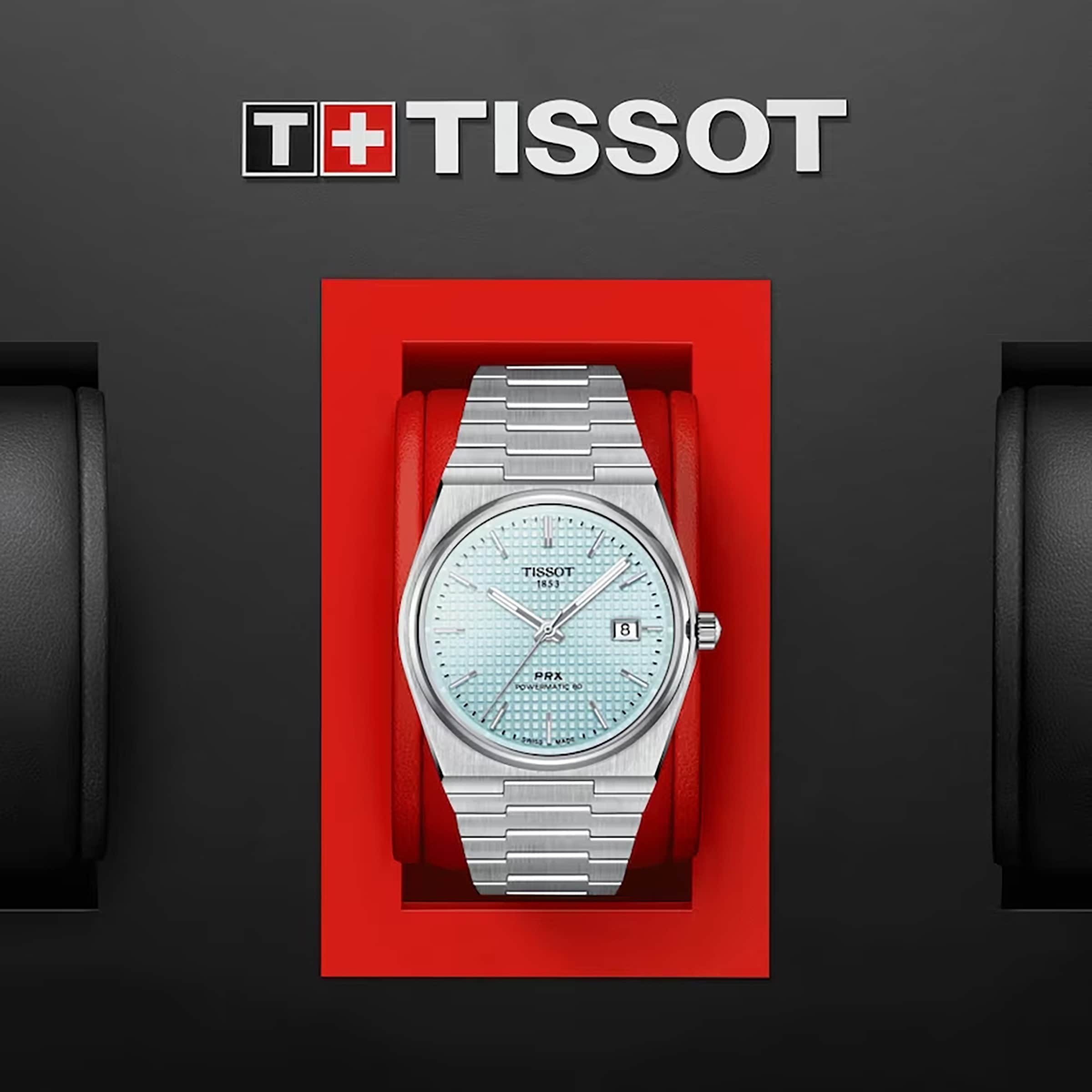 The Tissot PRX Powermatic 80, a silver wristwatch with a light blue face and stainless steel case, is displayed in a red box beneath the Tissot logo on a black background.