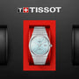 The Tissot PRX Powermatic 80, a silver wristwatch with a light blue face and stainless steel case, is displayed in a red box beneath the Tissot logo on a black background.