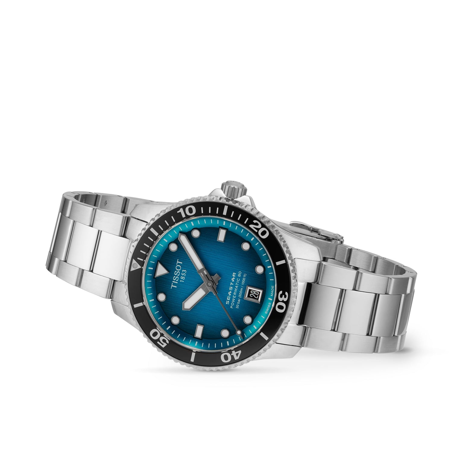 The Tissot Seastar 1000 Powermatic 80 is a stainless steel 40mm automatic watch with a blue gradient dial, date display, and black rotating bezel, shown at an angle to highlight the bracelet and face.