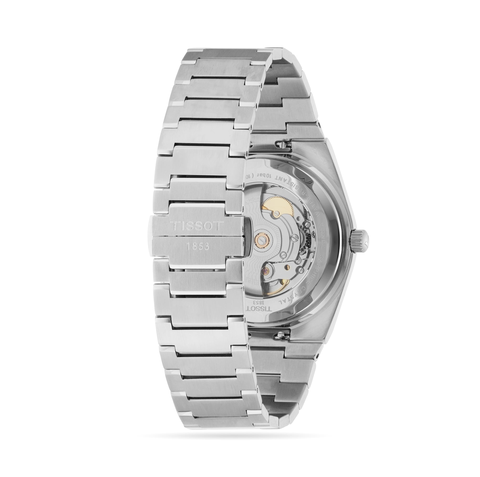 The Tissot PRX Powermatic 80 is shown from the back, revealing its automatic movement with a Nivachron hairspring through a transparent case back and showcasing a sleek stainless steel bracelet.