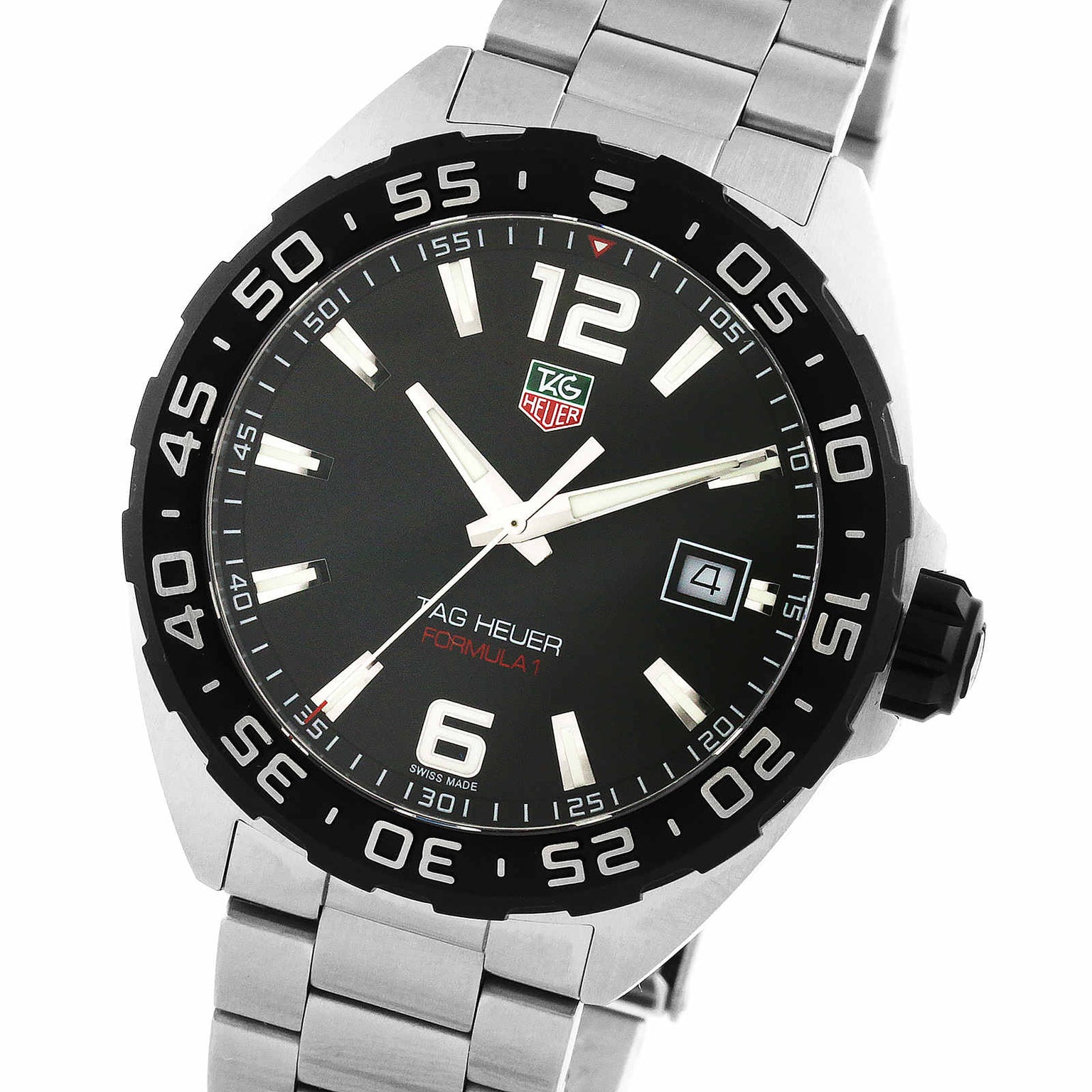 The TAG Heuer Formula 1 Date features a stainless steel case, black dial with white hour markers, date display at 3 o’clock, metal link bracelet, and quartz movement.