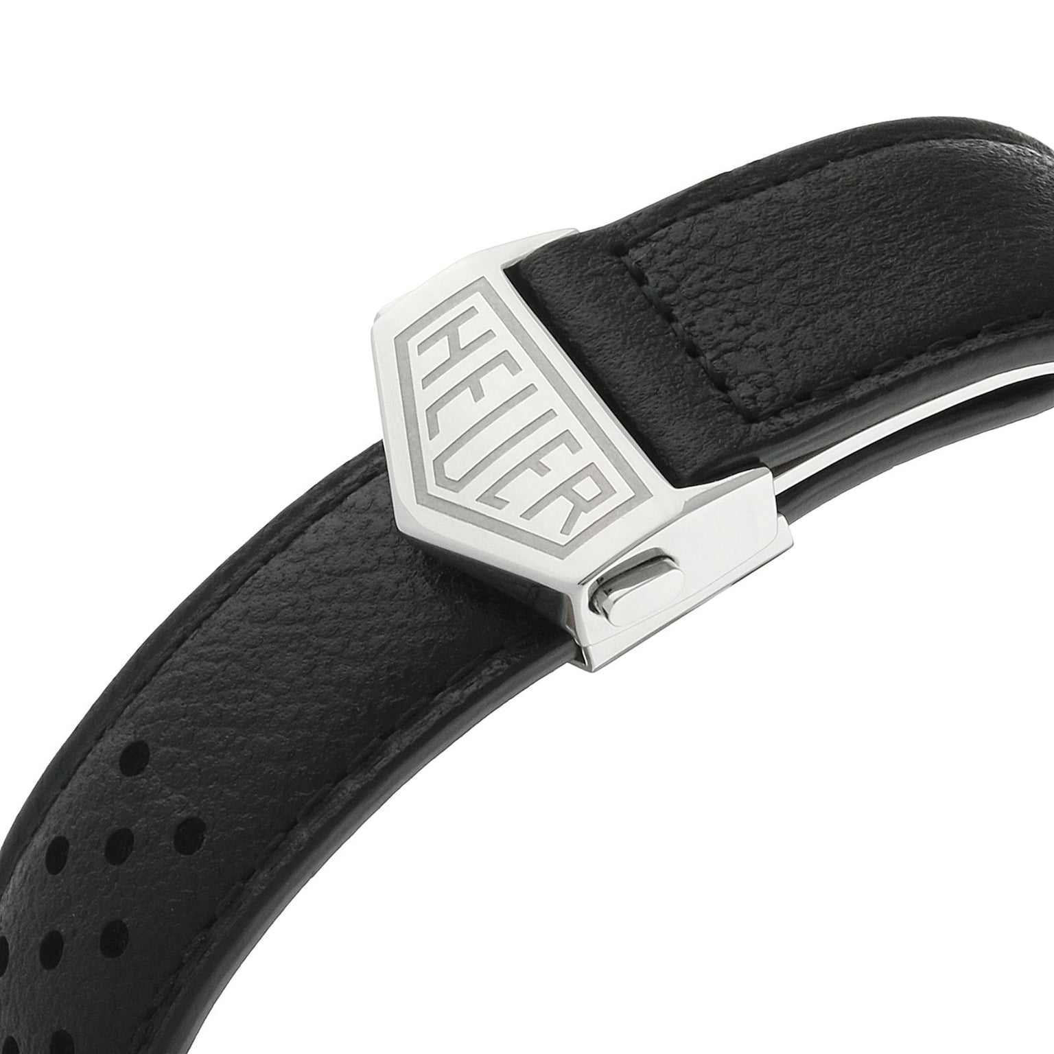 Close-up of a black leather strap with perforated design and metal clasp engraved with TAG Heuer, inspired by the iconic Monaco Chronograph worn by Steve McQueen.