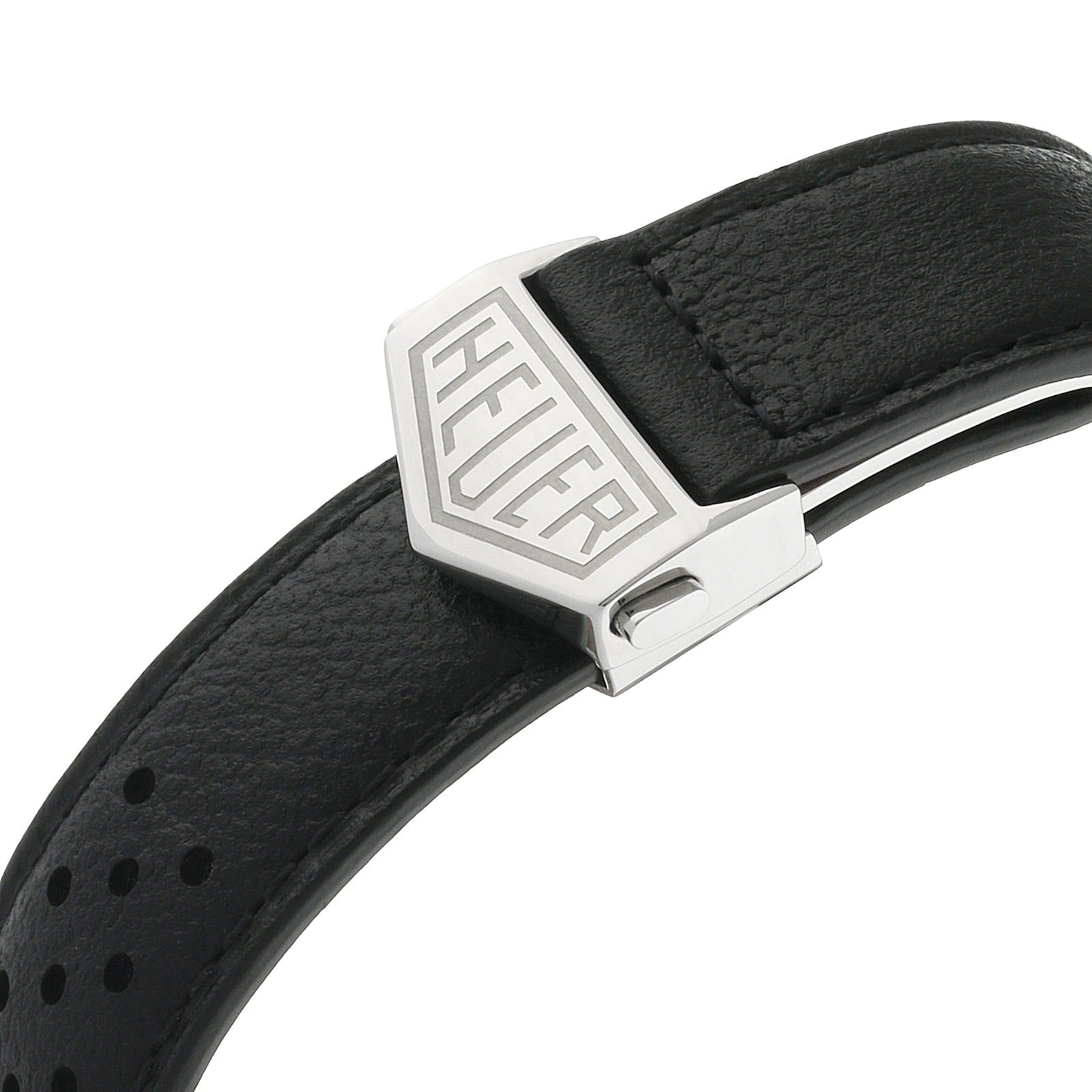 Close-up of a black leather strap with perforated design and metal clasp engraved with TAG Heuer, inspired by the iconic Monaco Chronograph worn by Steve McQueen.