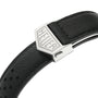 Close-up of a black leather strap with perforated design and metal clasp engraved with TAG Heuer, inspired by the iconic Monaco Chronograph worn by Steve McQueen.