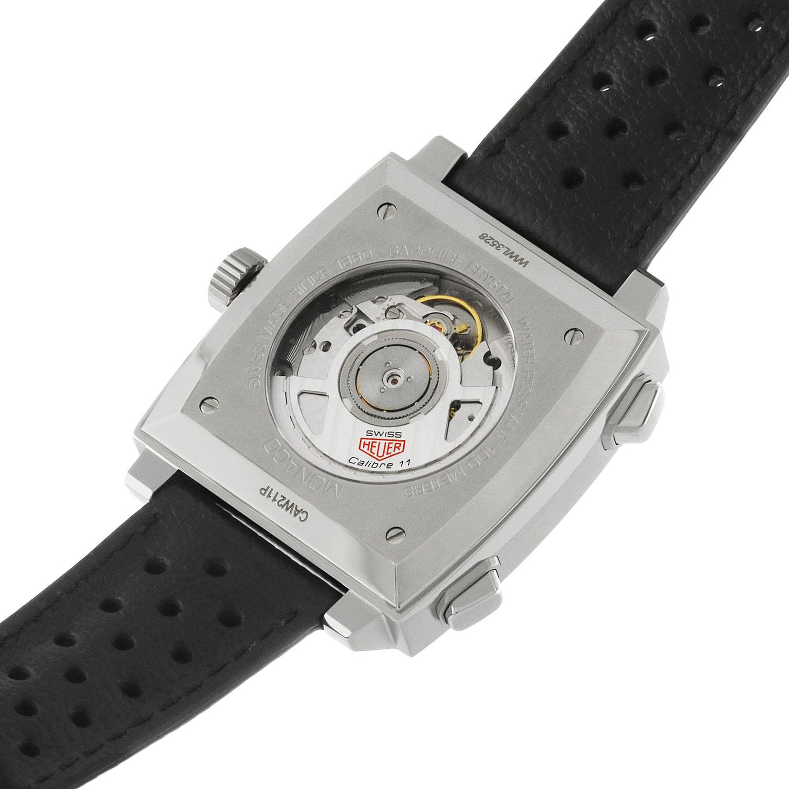 Back view of the TAG Heuer Monaco Chronograph, highlighting its automatic movement through a transparent case back and a perforated black leather strap inspired by Steve McQueen.