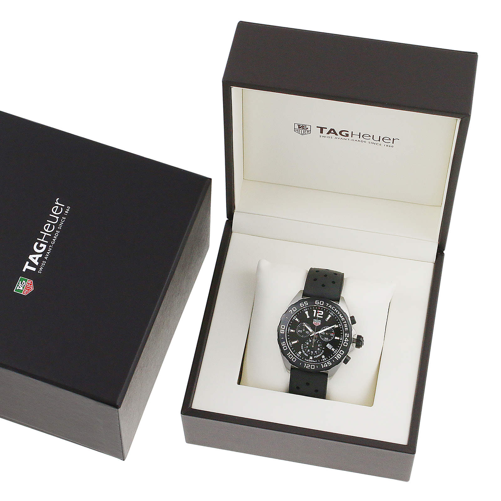 A TAG Heuer Formula 1 Chronograph watch with a black strap is shown in an open TAG Heuer box, alongside its closed packaging.