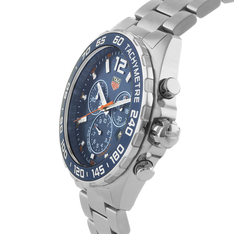 A close-up of the TAG Heuer Formula 1 Chronograph wristwatch showcasing its stainless steel case, blue tachymeter bezel, linked metal bracelet, and reliable quartz movement.