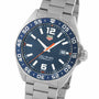 The TAG Heuer Formula 1 Date is a stainless steel watch featuring a blue sunray dial, bold white numerals, orange second hand, date at 3 o’clock, silver metal band, and reliable quartz movement.