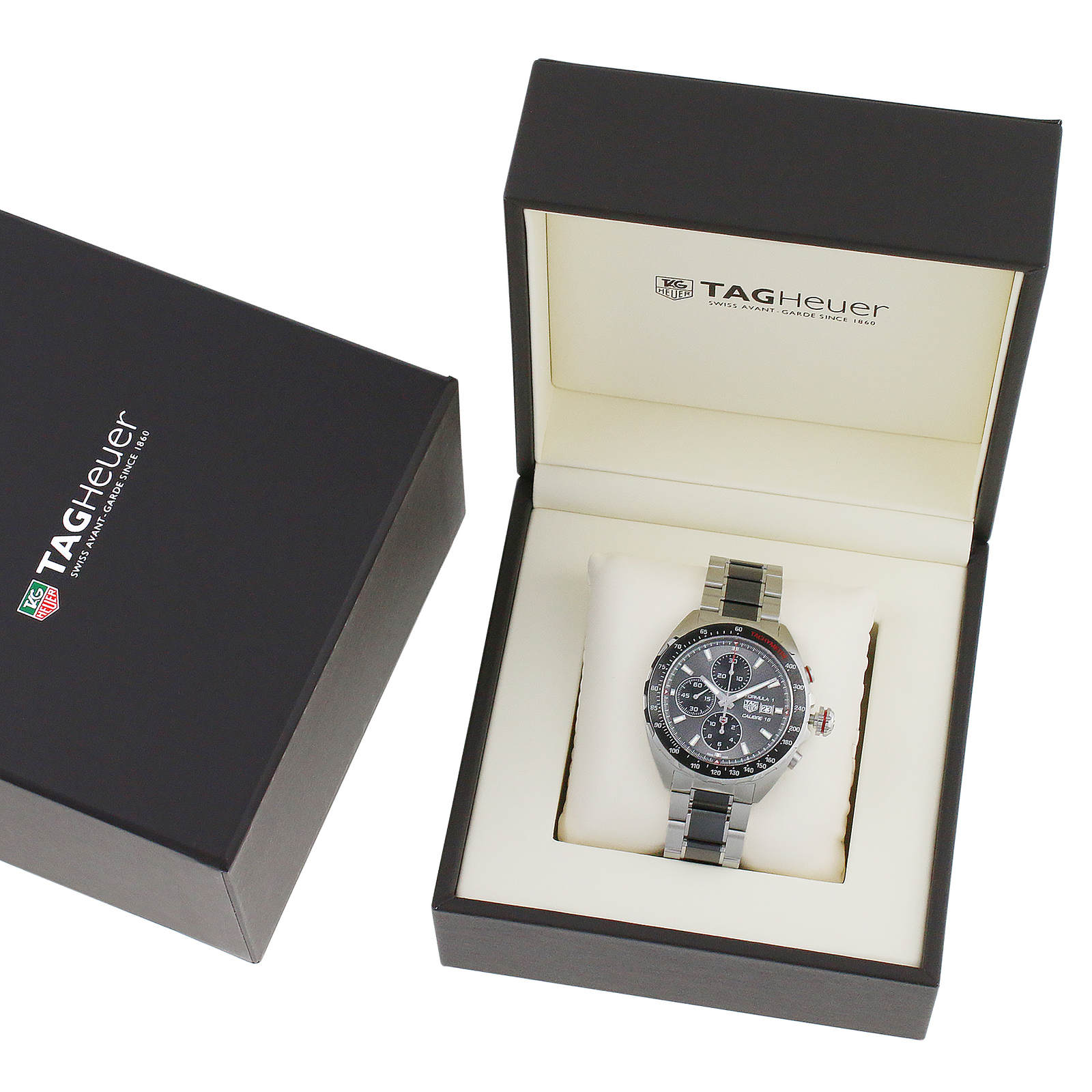 A TAG Heuer Formula 1 Chronograph wristwatch with a metal band is shown in an open branded box, featuring the TAG Heuer logo on the lid and equipped with a precision calibre 16 movement.
