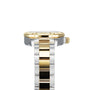 Close-up side view of the TAG Heuer Aquaracer Date wristwatch with a gold bezel and crown, crafted in stainless steel and 18K gold, featuring a silver and gold link bracelet against a white background.