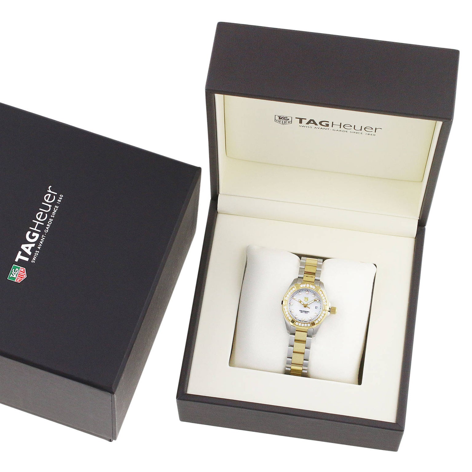 A TAG Heuer Aquaracer Date wristwatch with a stainless steel and 18K gold band is presented in an open branded box, with the outer box placed to the left.