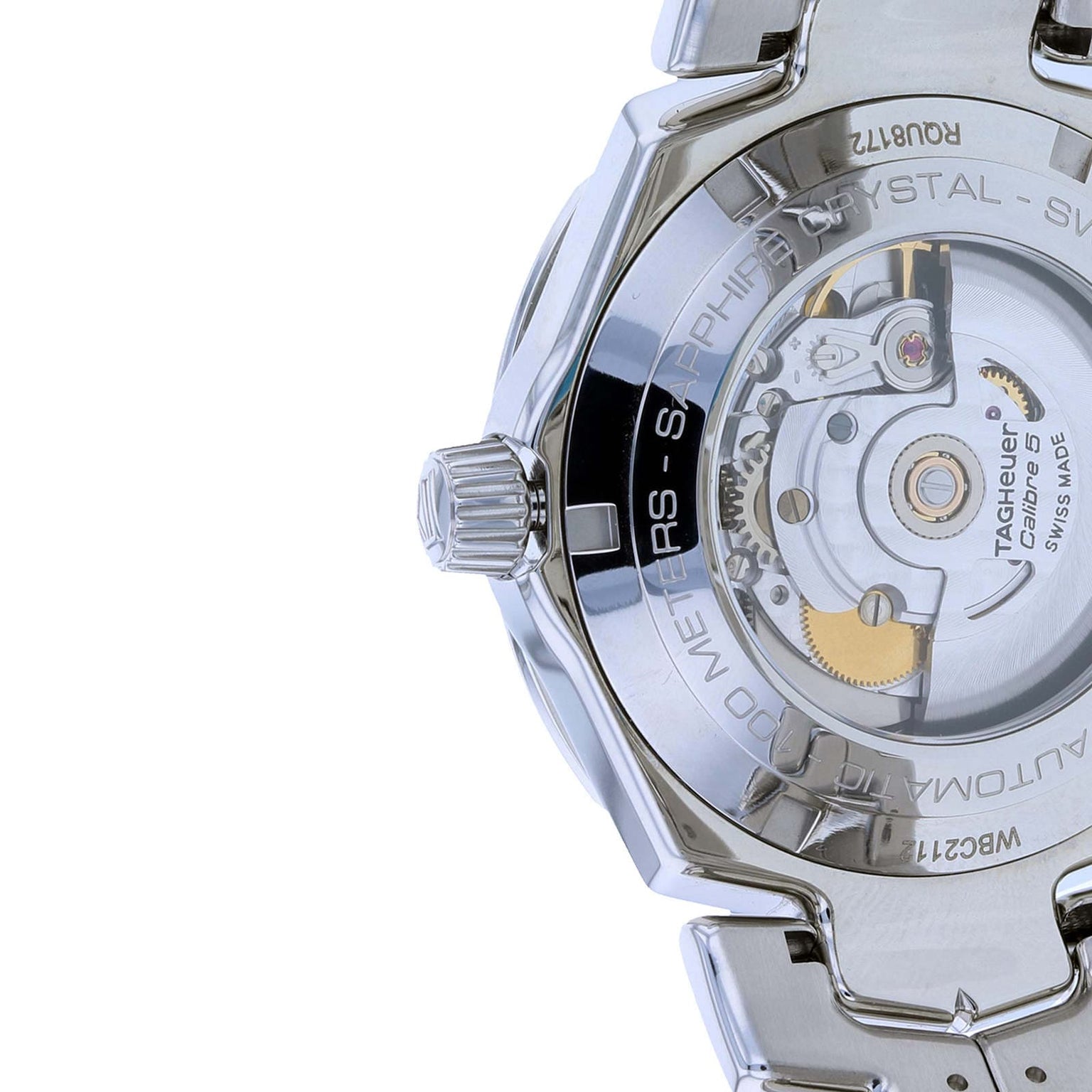 Close-up of the back of the TAG Heuer Link Date watch, showcasing its mechanical movement and engraved details on the stainless steel case under sapphire crystal glass.