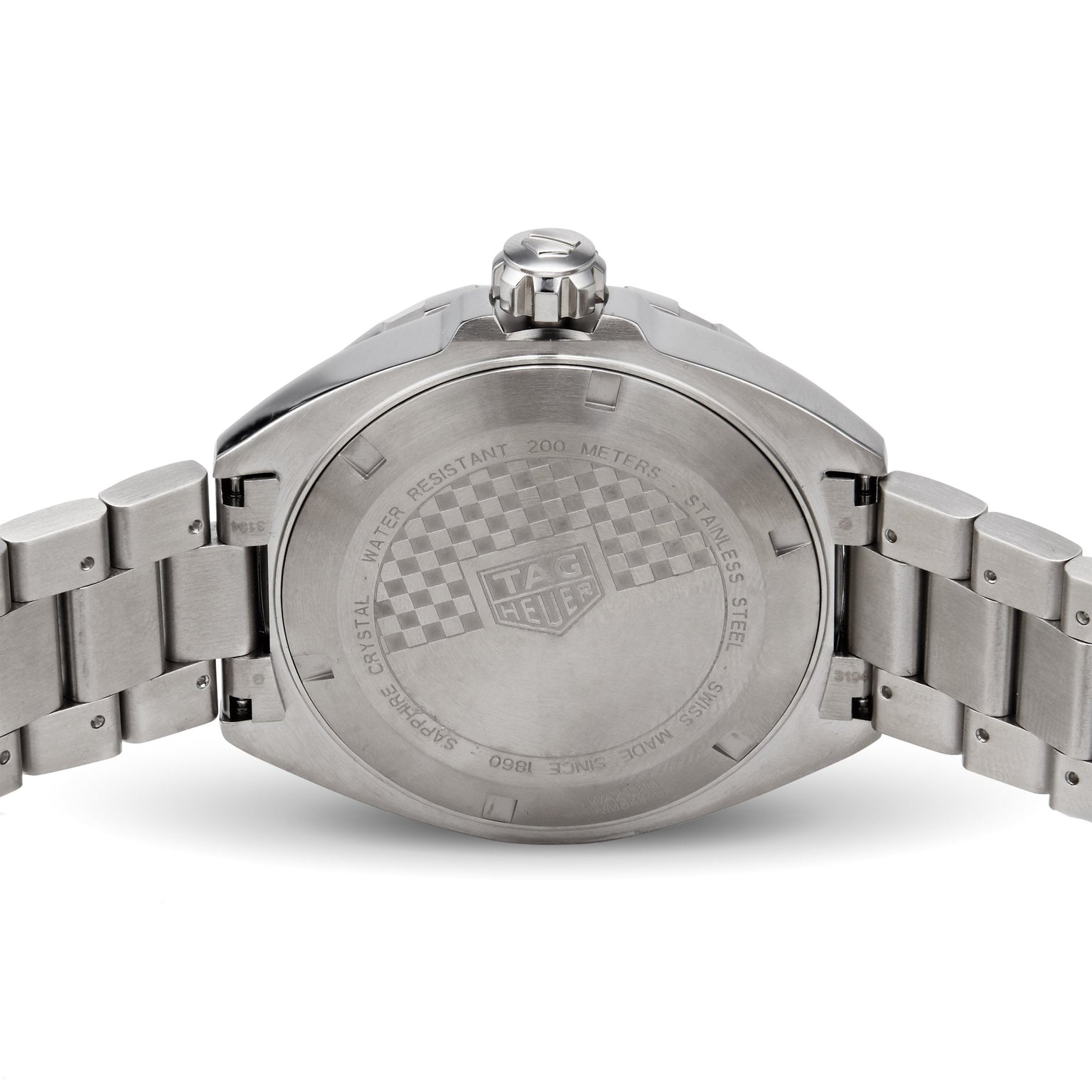 The back of a TAG Heuer Formula 1 Date stainless steel watch displays engraved details about water resistance, sapphire crystal, and model information.