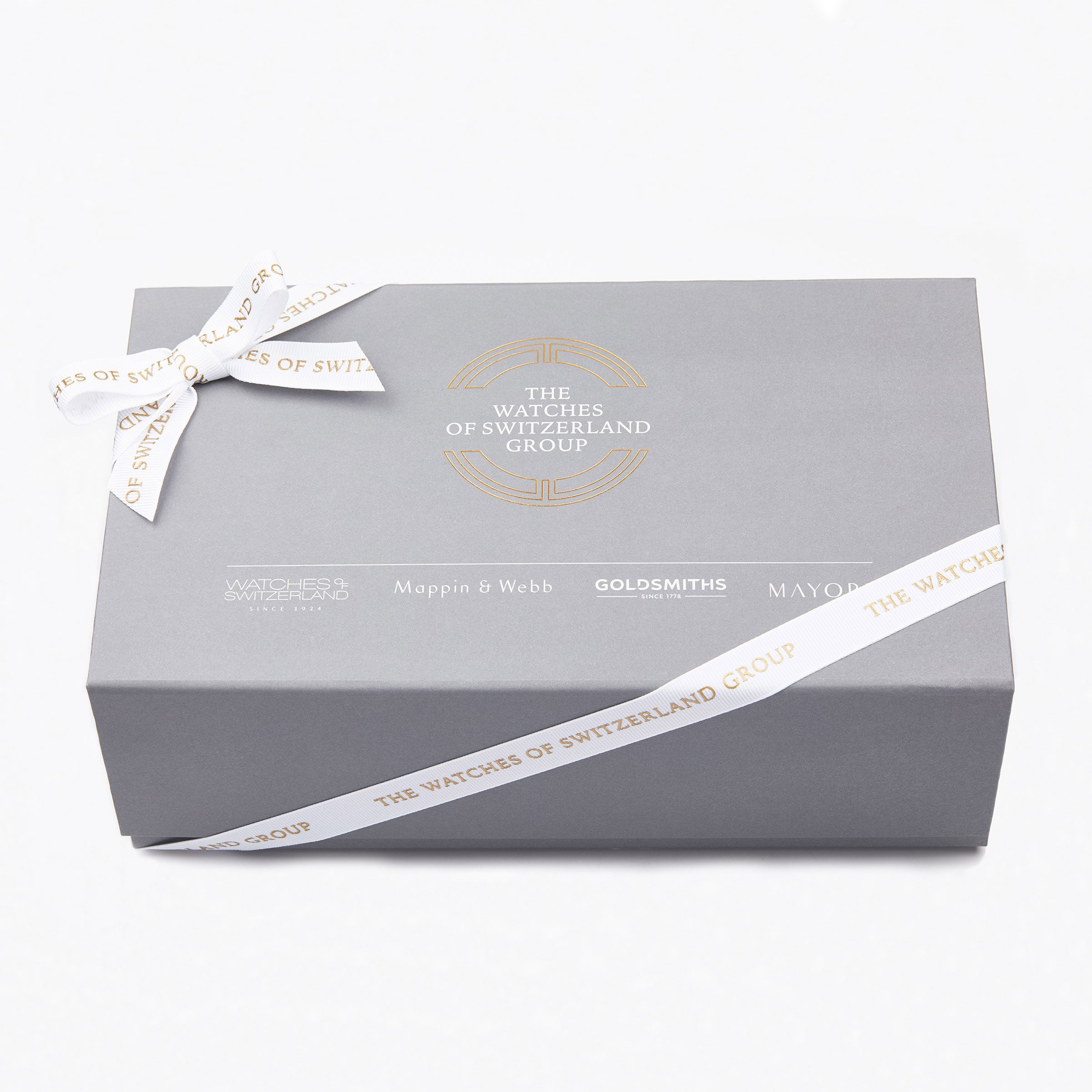 A grey gift box with a white ribbon, displaying The Watches of Switzerland Group logo and brands like Mappin & Webb, Goldsmiths, and Mayors—a perfect presentation for the TAG Heuer Formula 1 Date watch.