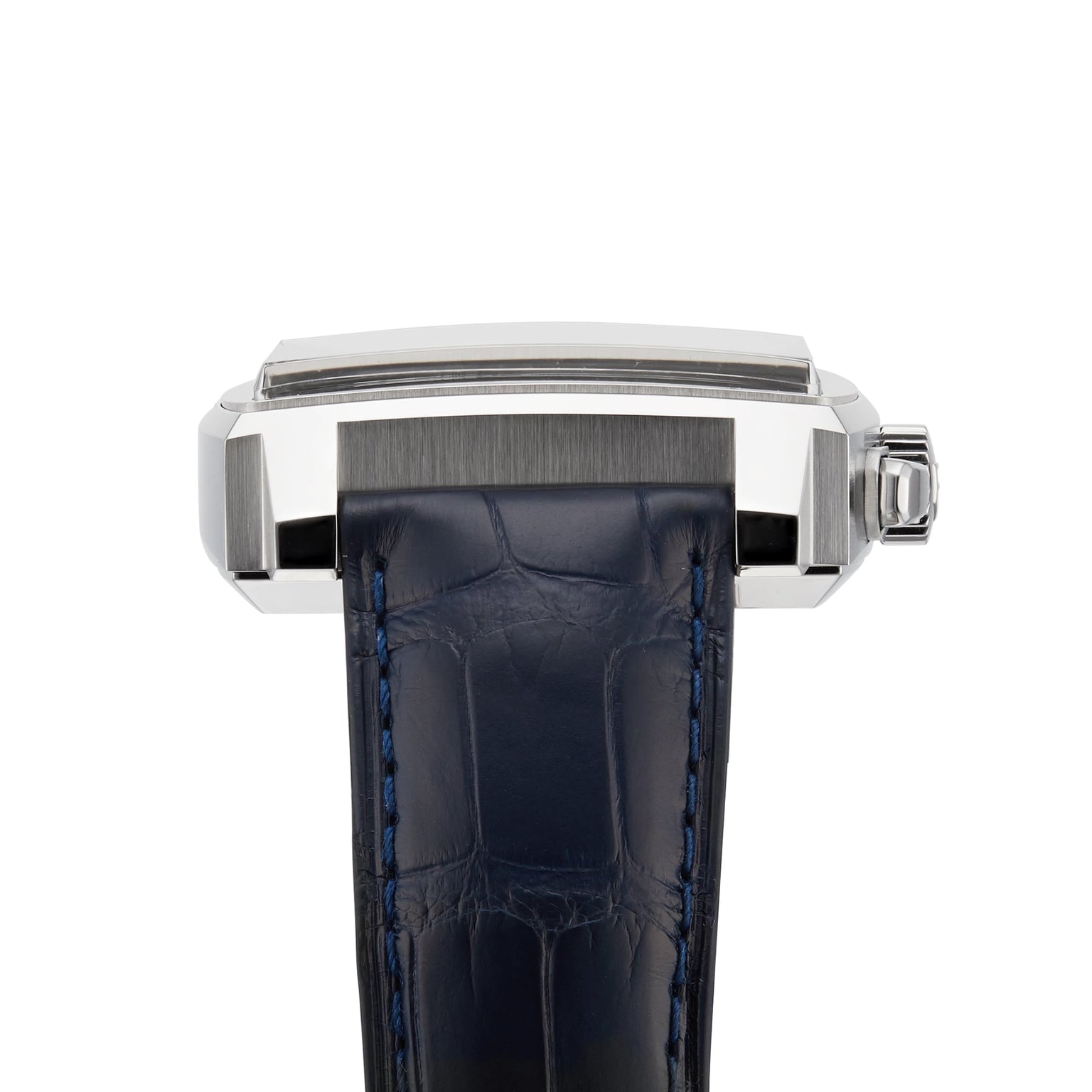 Close-up side view of the TAG Heuer Monaco Chronograph, featuring a square case with a silver bezel and a textured dark blue leather strap.