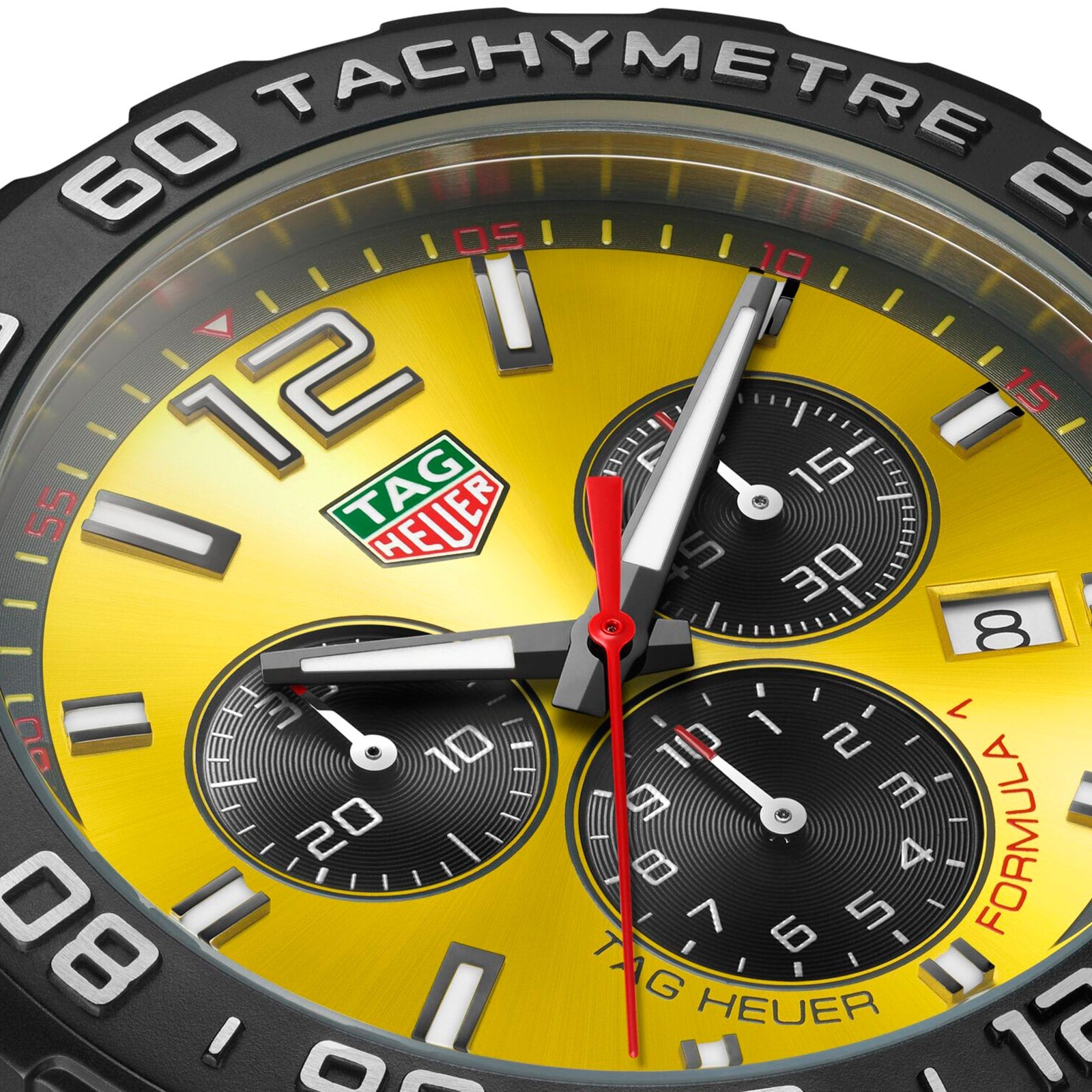 Close-up of the TAG Heuer Formula 1 Chronograph watch face, featuring three black subdials, date display, tachymeter bezel, precise quartz movement, and a yellow background.