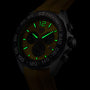 The TAG Heuer Formula 1 Chronograph wristwatch, shown in a dark setting, features a yellow face and strap, green luminescent markers and hands, quartz movement, and a tachymeter bezel.
