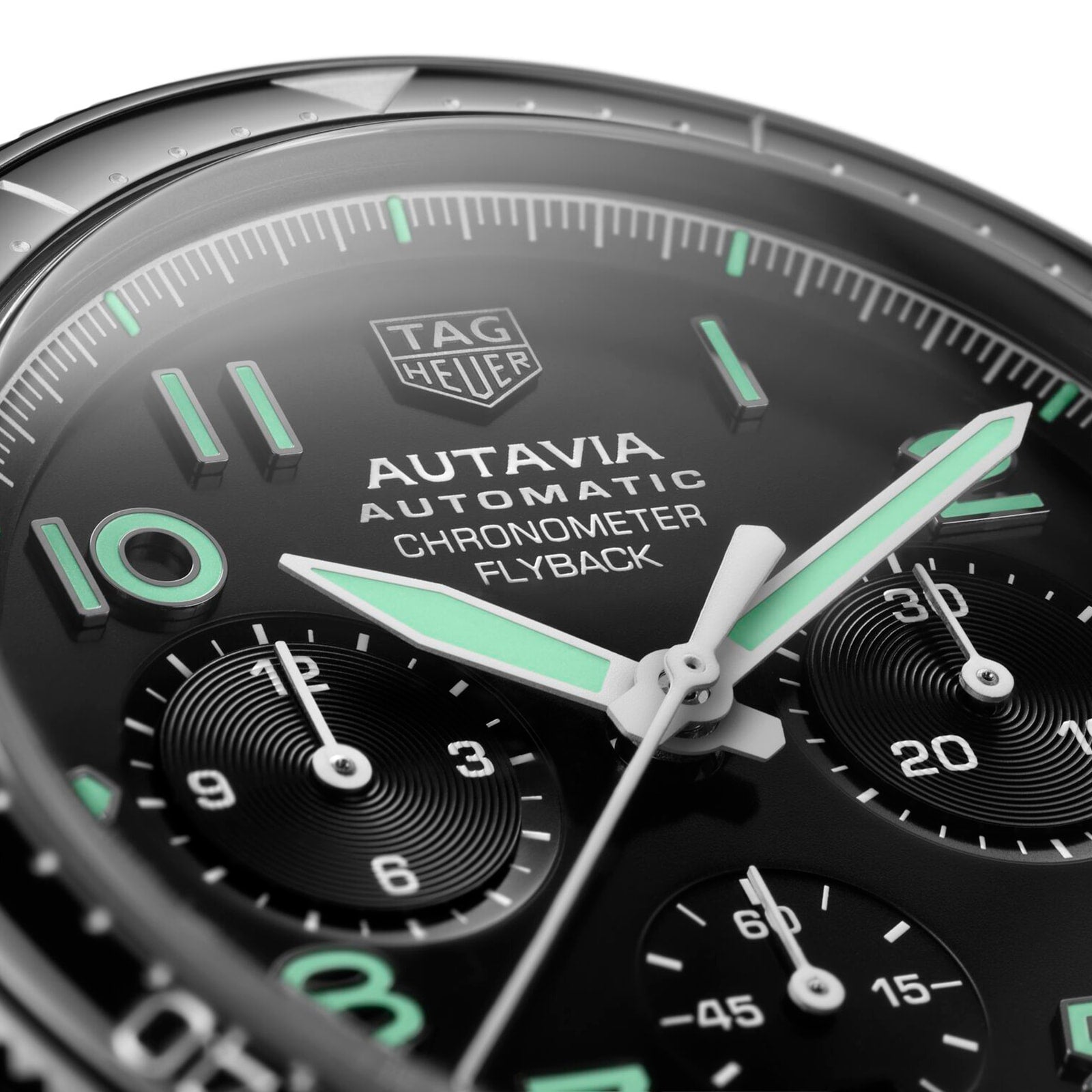 Close-up of the TAG Heuer Autavia Flyback Chronometer watch face, showcasing luminous hands, markers, three subdials, and the calibre 02 Flyback movement.